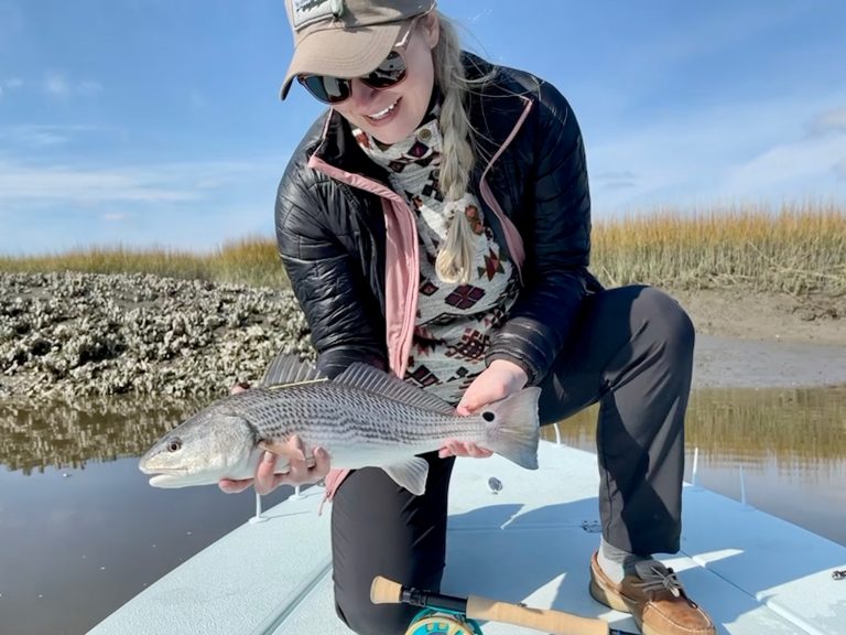 megan shurites founder of guider adventure holding a redfish