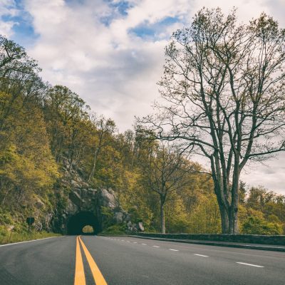 Road going through rock tunnel on Skyline Drive in Shenandoah National Park on the way to an adventure tour