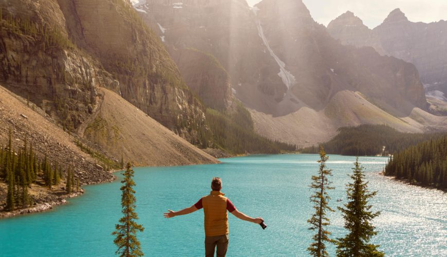 man on guided forest bathing walk overlooking blue lake