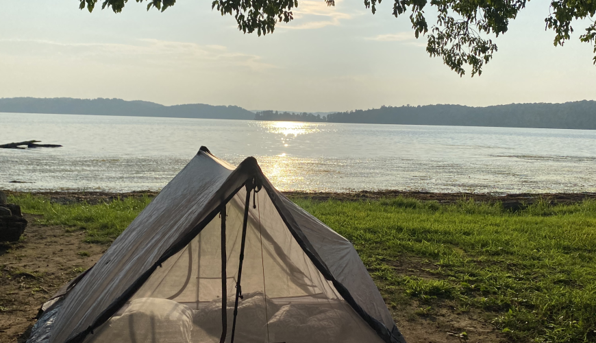 tent camping on the edge of a lake