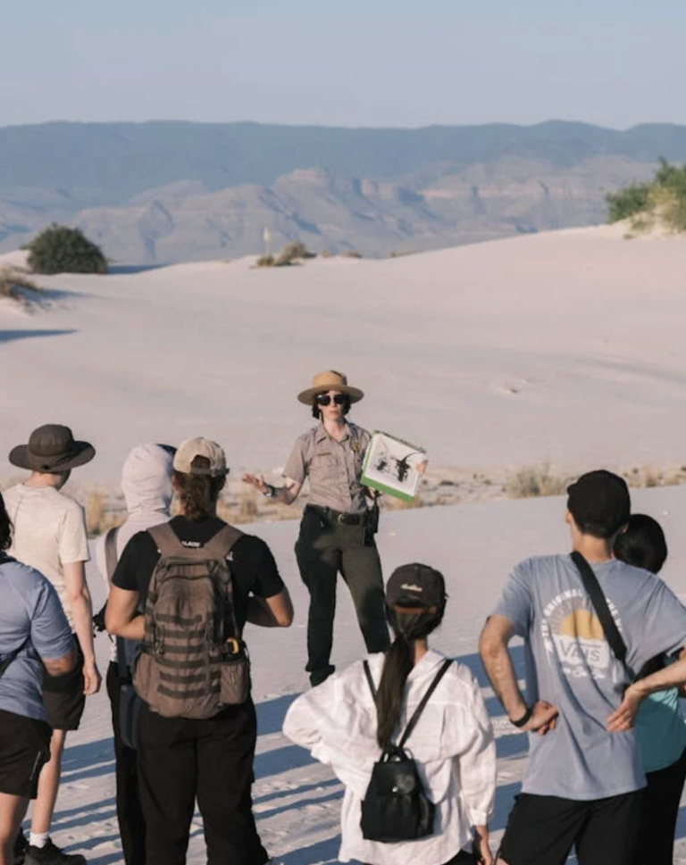 a tour guide educating clients before going on a walking tour in white sands national park