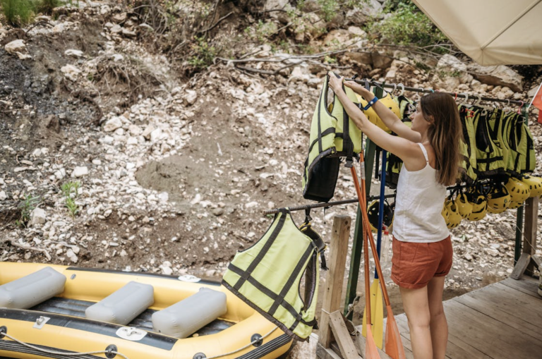 tour guide puts away life jackets after rafting tour