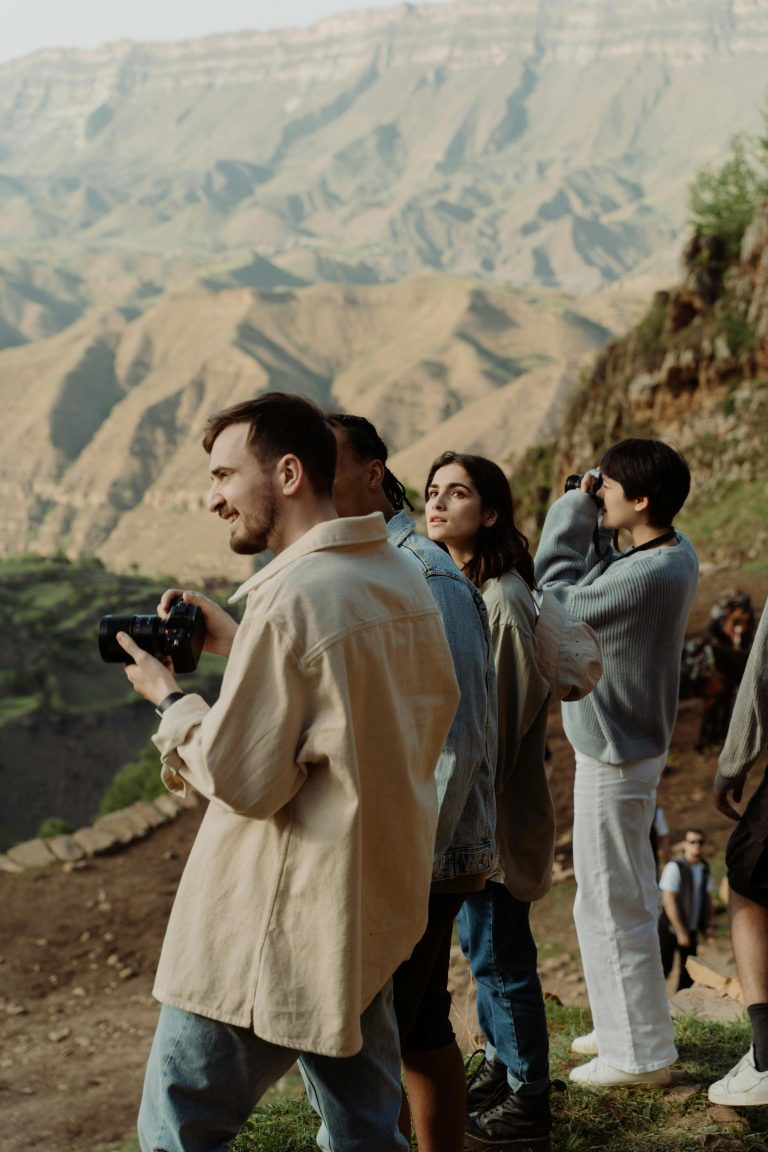 group of people taking photos on a tour in a desert national park after wondering if Beginners Do Guided Adventure Tours