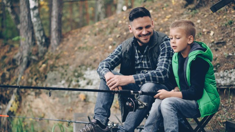 father fishing with son outdoors for fathers day