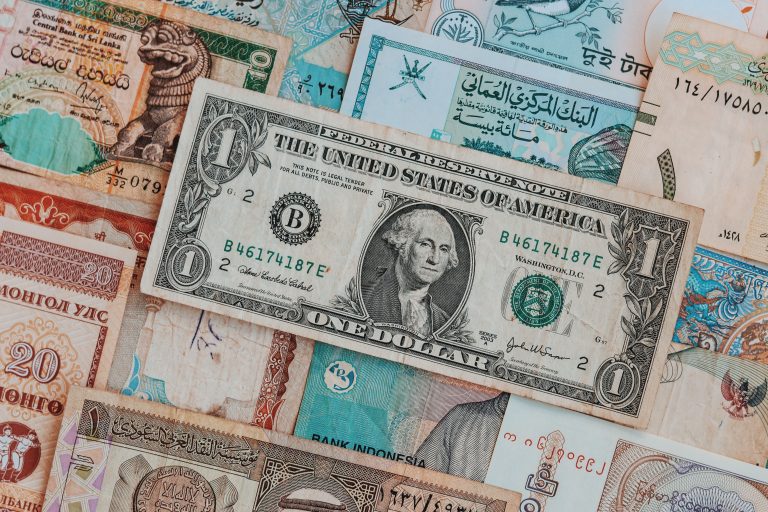 various types of international currency layered on top of each other