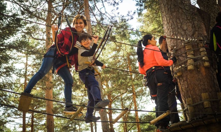 family of mom and two kids ziplining